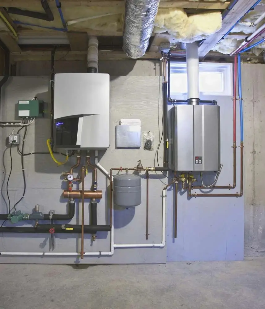 Tankless water heater and boiler professionally installed in a basement mechanical room